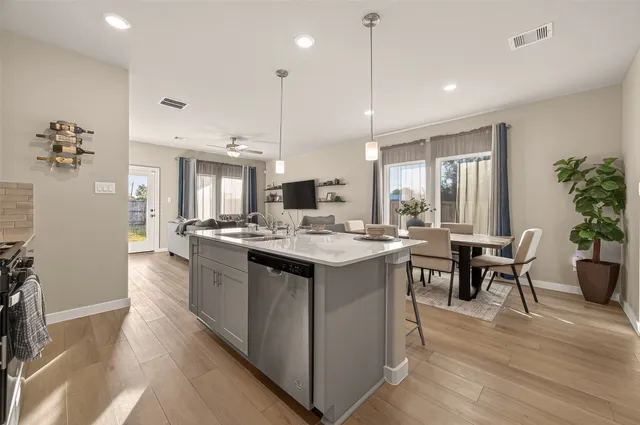 a kitchen with stainless steel appliances granite countertop a sink a stove and a microwave