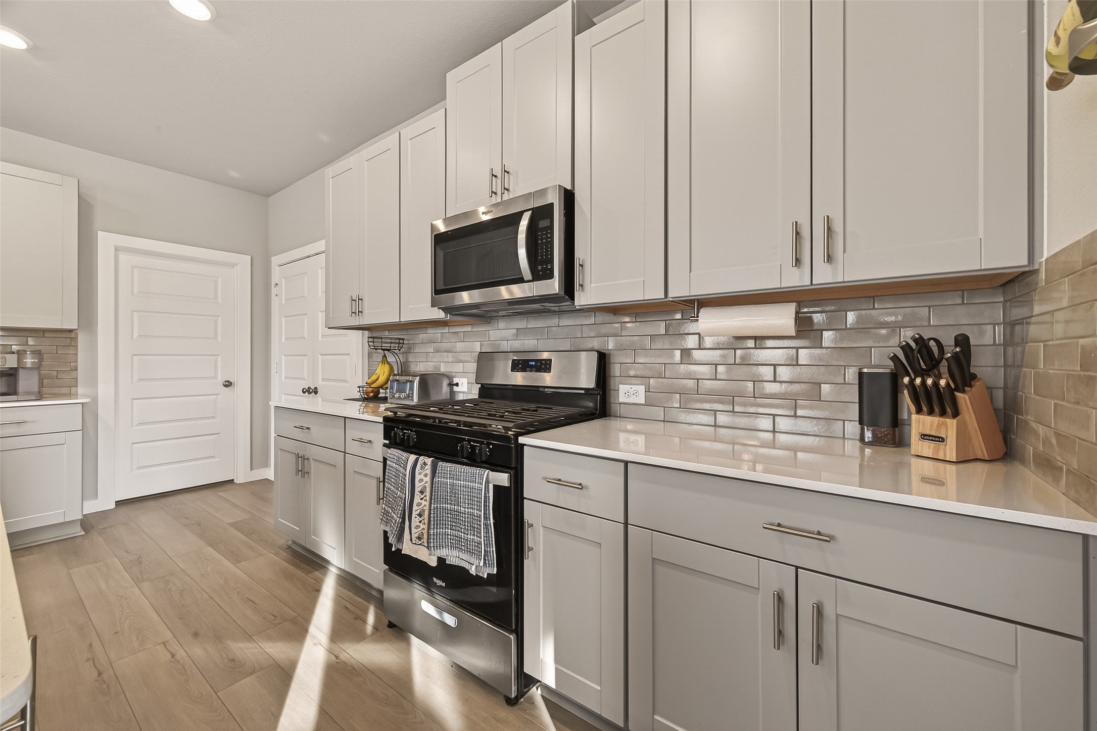 5516 Madden Lane Houston, TX 77048 - Photo 9 of 33 a kitchen with stainless steel appliances granite countertop a sink a stove and a microwave