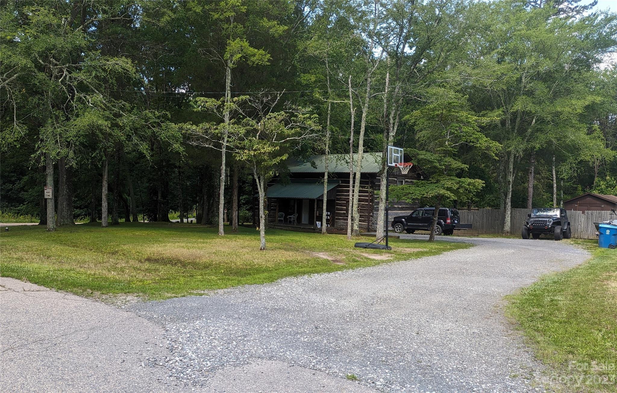 a view of a house with a yard and sitting area