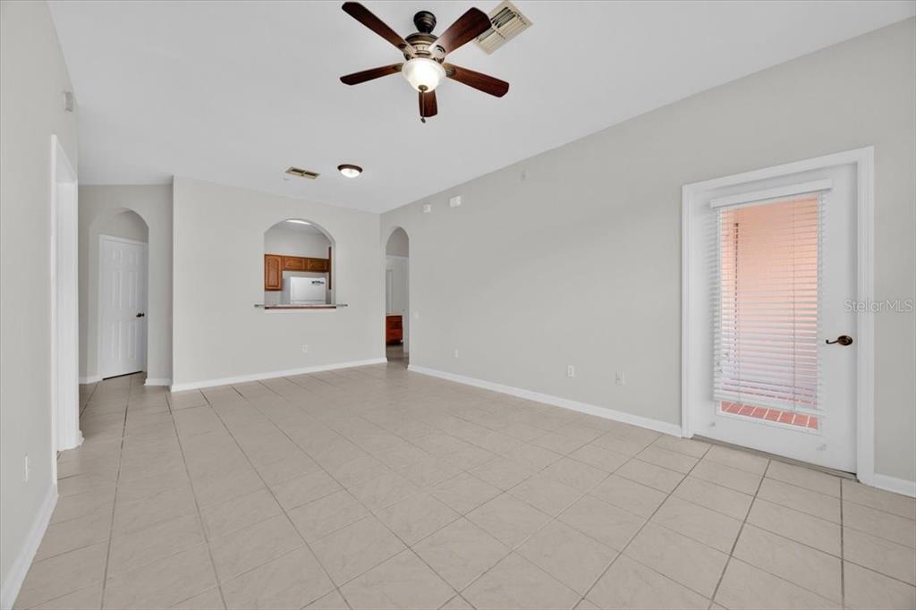 13524 Turtle Marsh Loop, Unit 621 Orlando, FL 32837 - Photo 11 of 26 an empty room with windows and fan