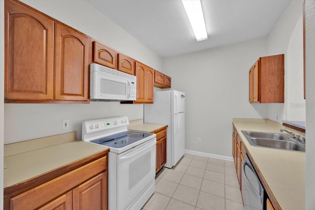 13524 Turtle Marsh Loop, Unit 621 Orlando, FL 32837 - Photo 14 of 26 a utility room with cabinets washer and dryer