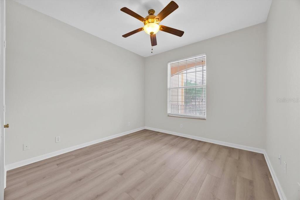 13524 Turtle Marsh Loop, Unit 621 Orlando, FL 32837 - Photo 15 of 26 an empty room with a window and a ceiling fan