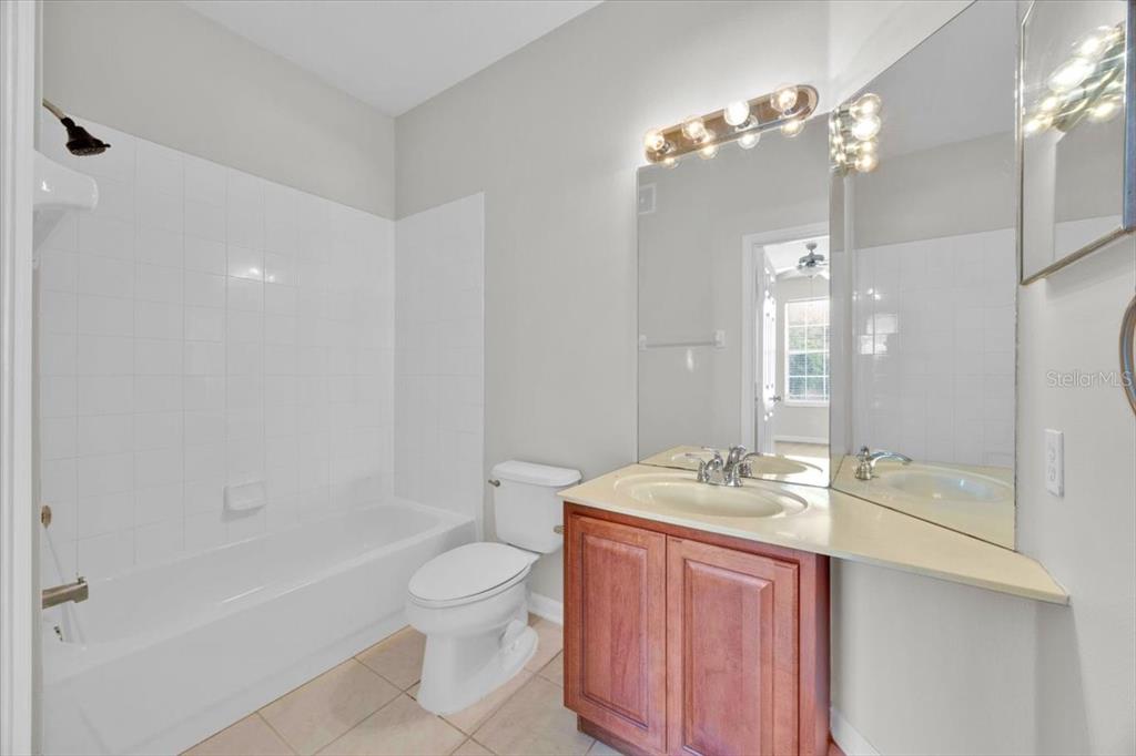 13524 Turtle Marsh Loop, Unit 621 Orlando, FL 32837 - Photo 19 of 26 a bathroom with a sink a toilet and shower