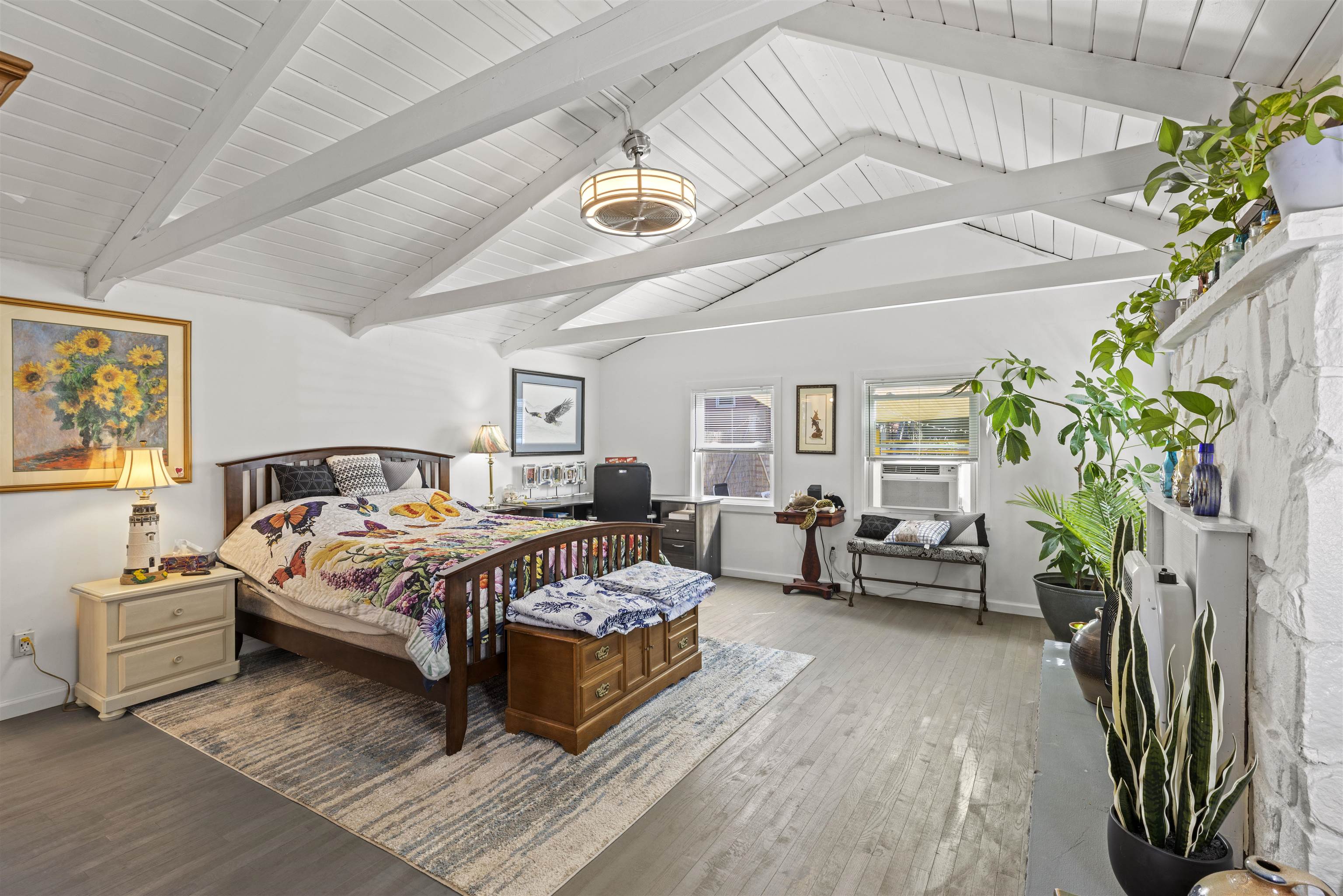 35 Bay Shore Road Cape May, NJ 08204 - Photo 14 of 45 a spacious bedroom with a bed and a potted plant