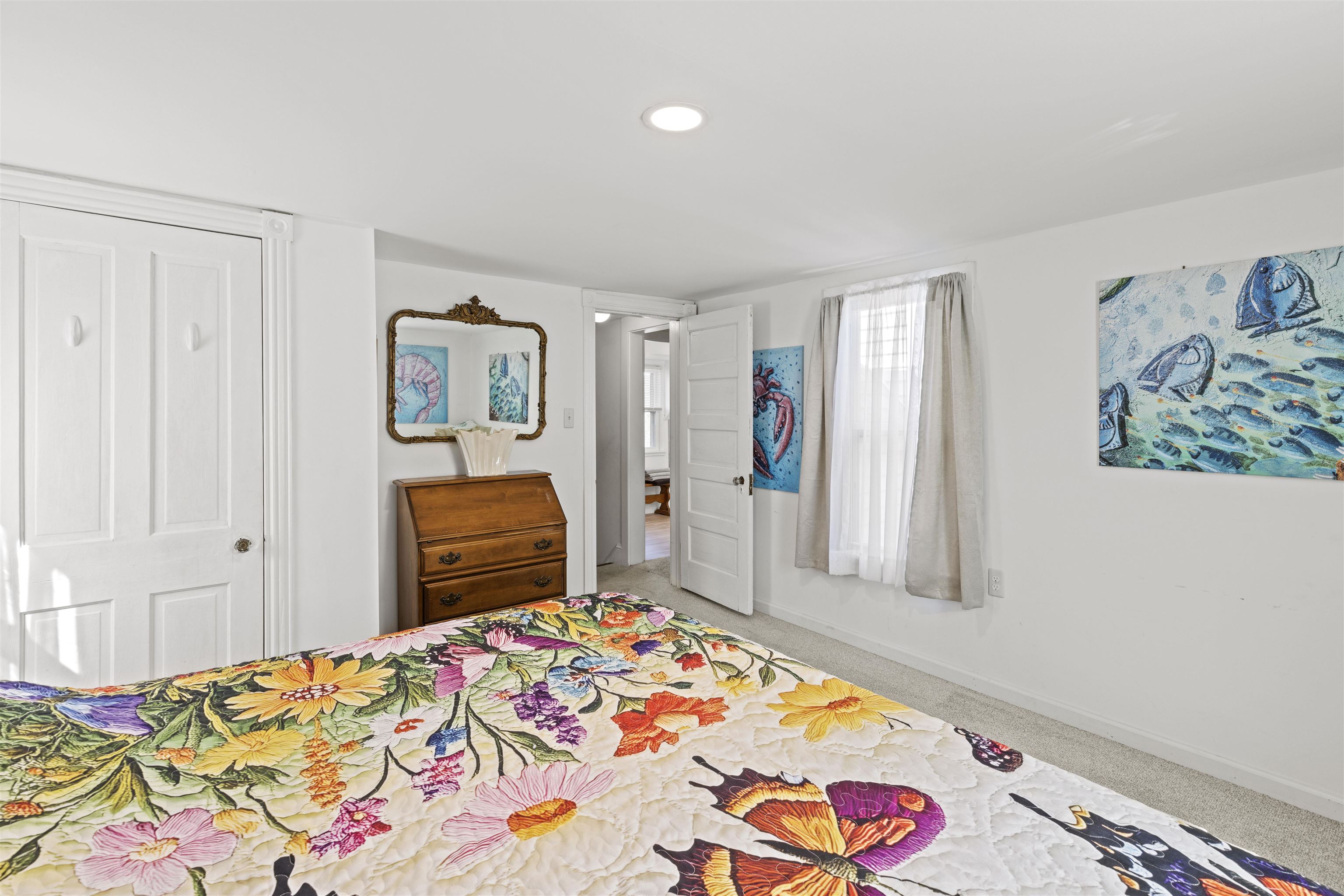 35 Bay Shore Road Cape May, NJ 08204 - Photo 17 of 45 a bedroom with a bed and a chandelier