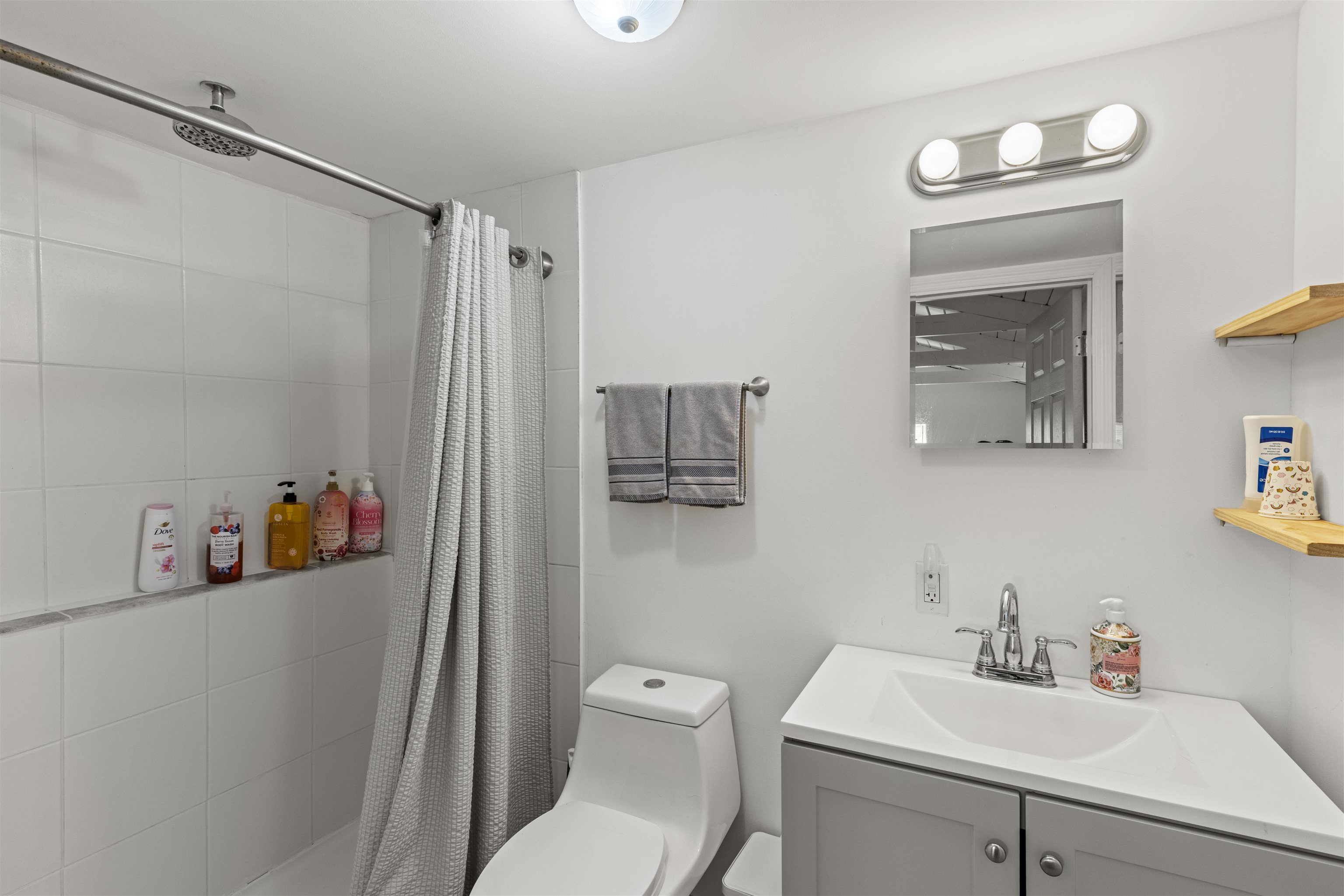 35 Bay Shore Road Cape May, NJ 08204 - Photo 20 of 45 a bathroom with a sink a toilet and shower curtain