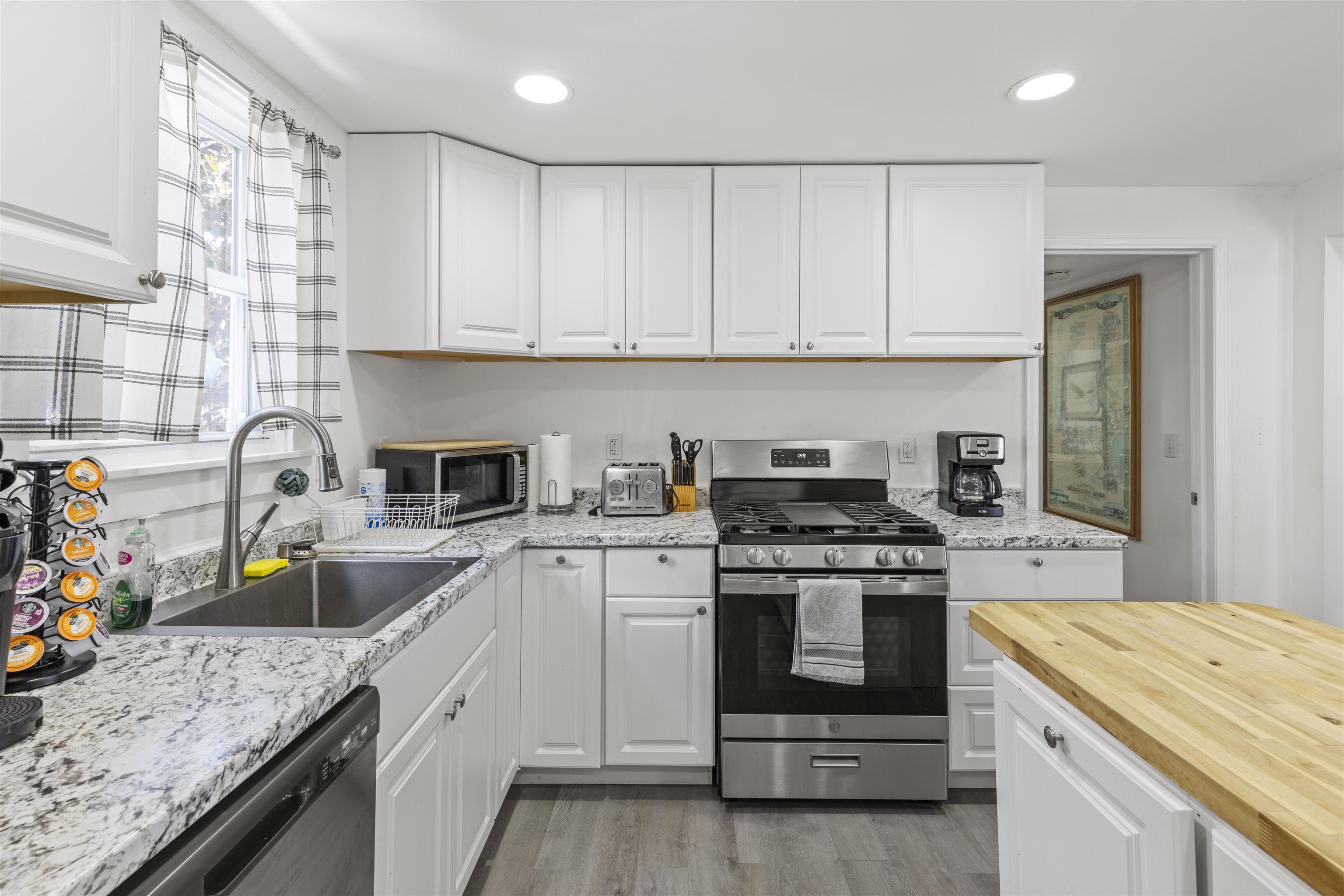 35 Bay Shore Road Cape May, NJ 08204 - Photo 6 of 45 a kitchen with stainless steel appliances granite countertop a stove and a sink