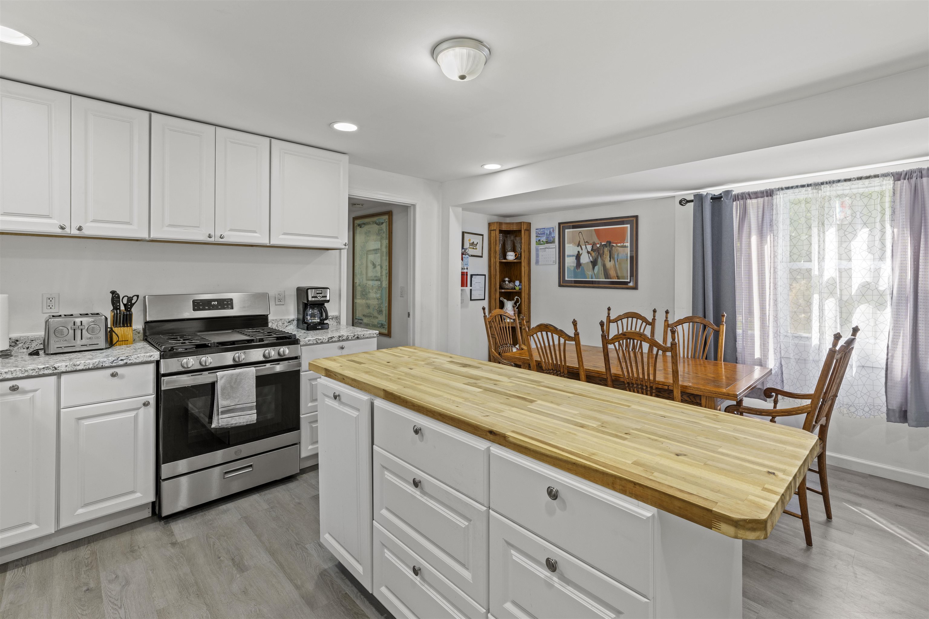35 Bay Shore Road Cape May, NJ 08204 - Photo 7 of 45 a large kitchen with granite countertop a stove a sink a dining table and chairs