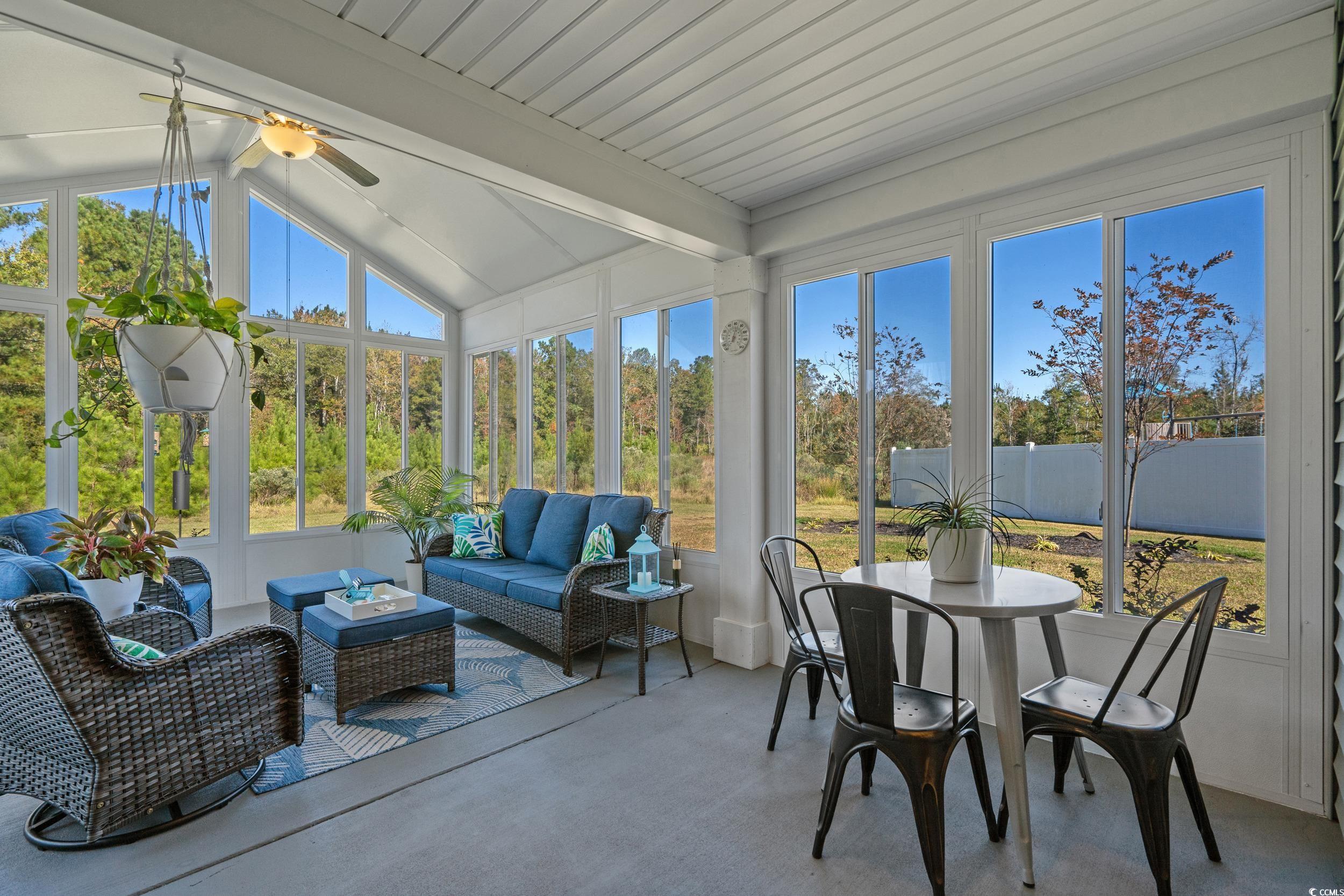 1803 Promise Pl. Myrtle Beach, SC 29588 - Photo 32 of 40 Sunroom / solarium featuring healthy amount of natural light, an outdoor hangout area, outdoor dining space, and a ceiling fan