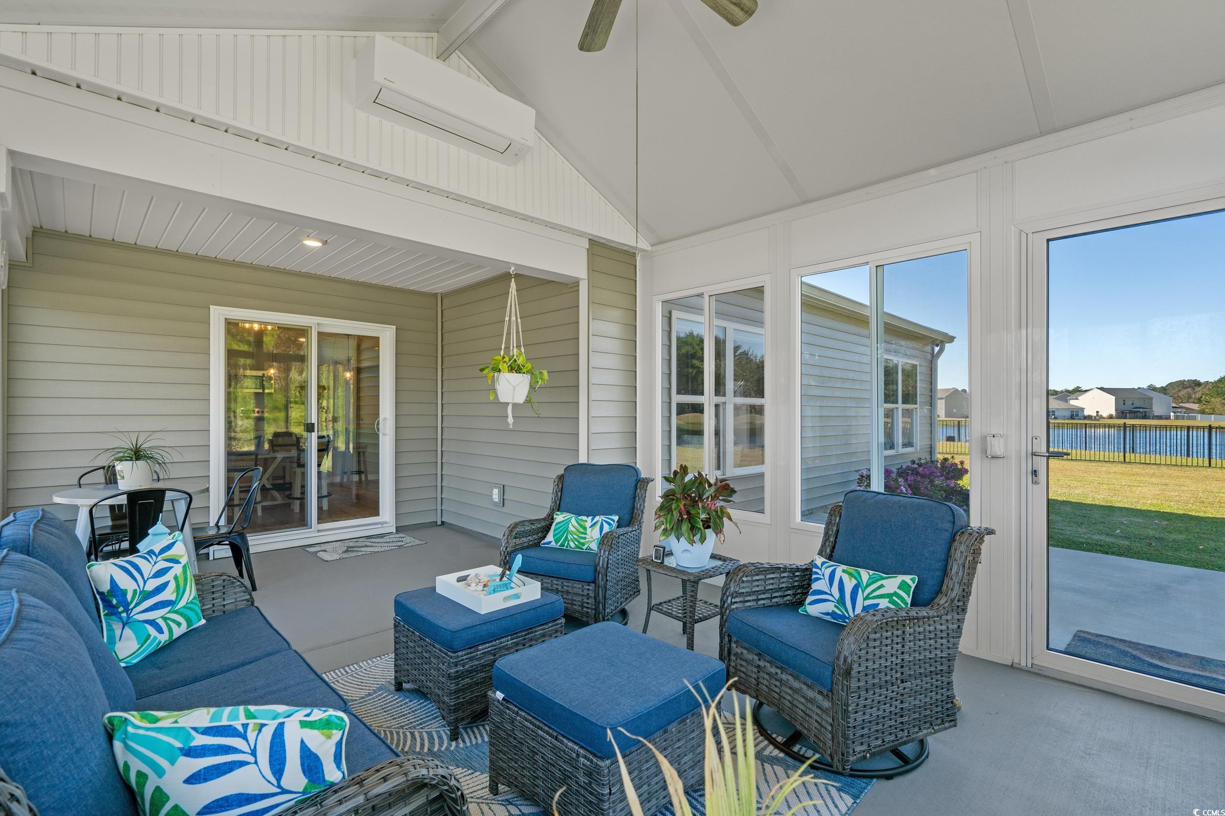 1803 Promise Pl. Myrtle Beach, SC 29588 - Photo 34 of 40 Sunroom featuring a ceiling fan, a wall unit AC, an outdoor living space, and a water view