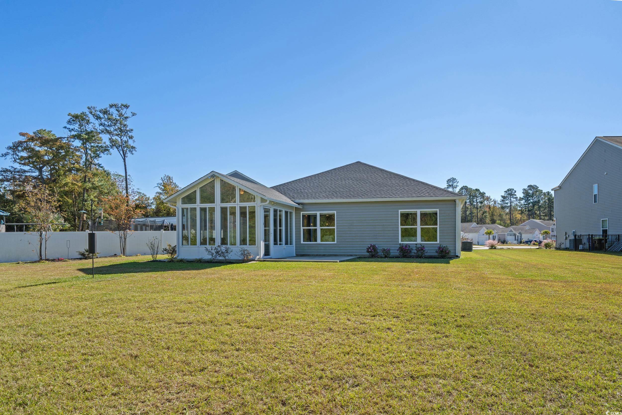 1803 Promise Pl. Myrtle Beach, SC 29588 - Photo 38 of 40 Rear view of house featuring a sunroom and a shingled roof