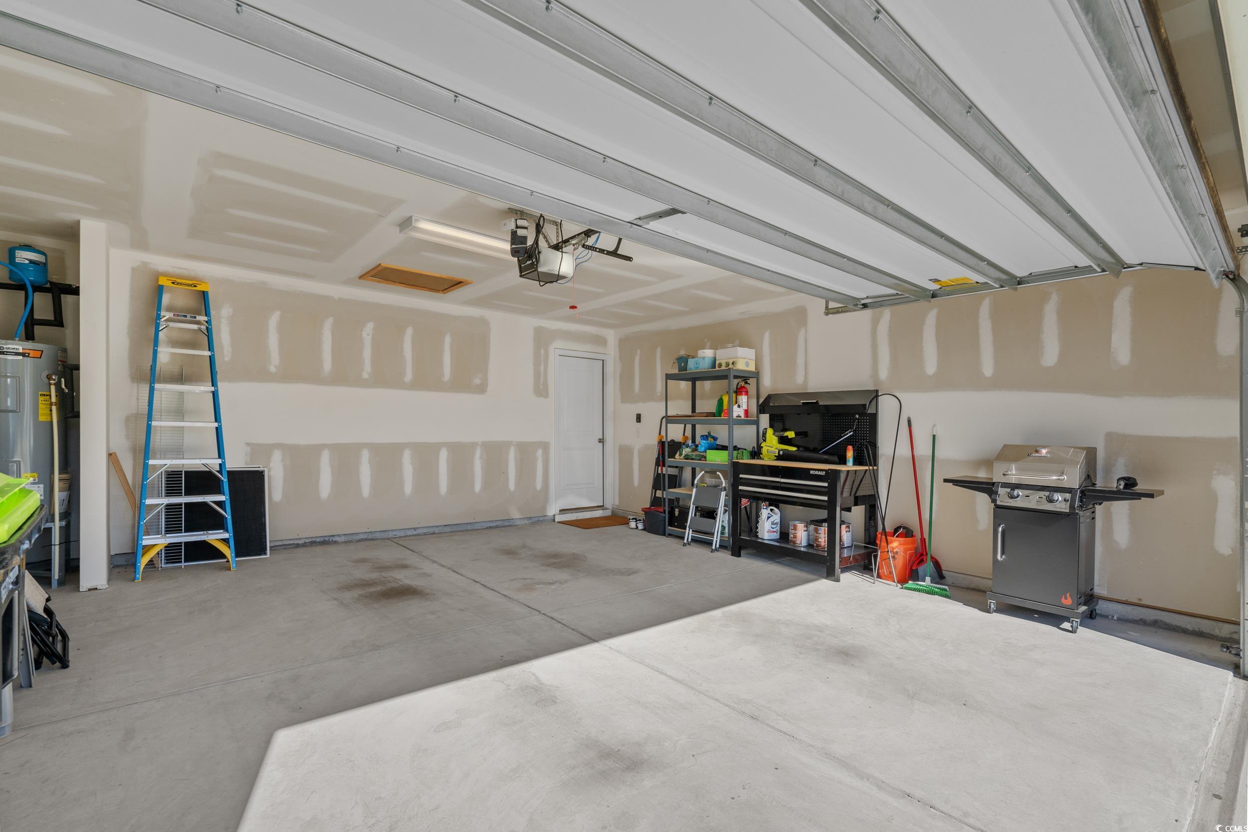 1803 Promise Pl. Myrtle Beach, SC 29588 - Photo 39 of 40 Garage featuring water heater and a garage door opener