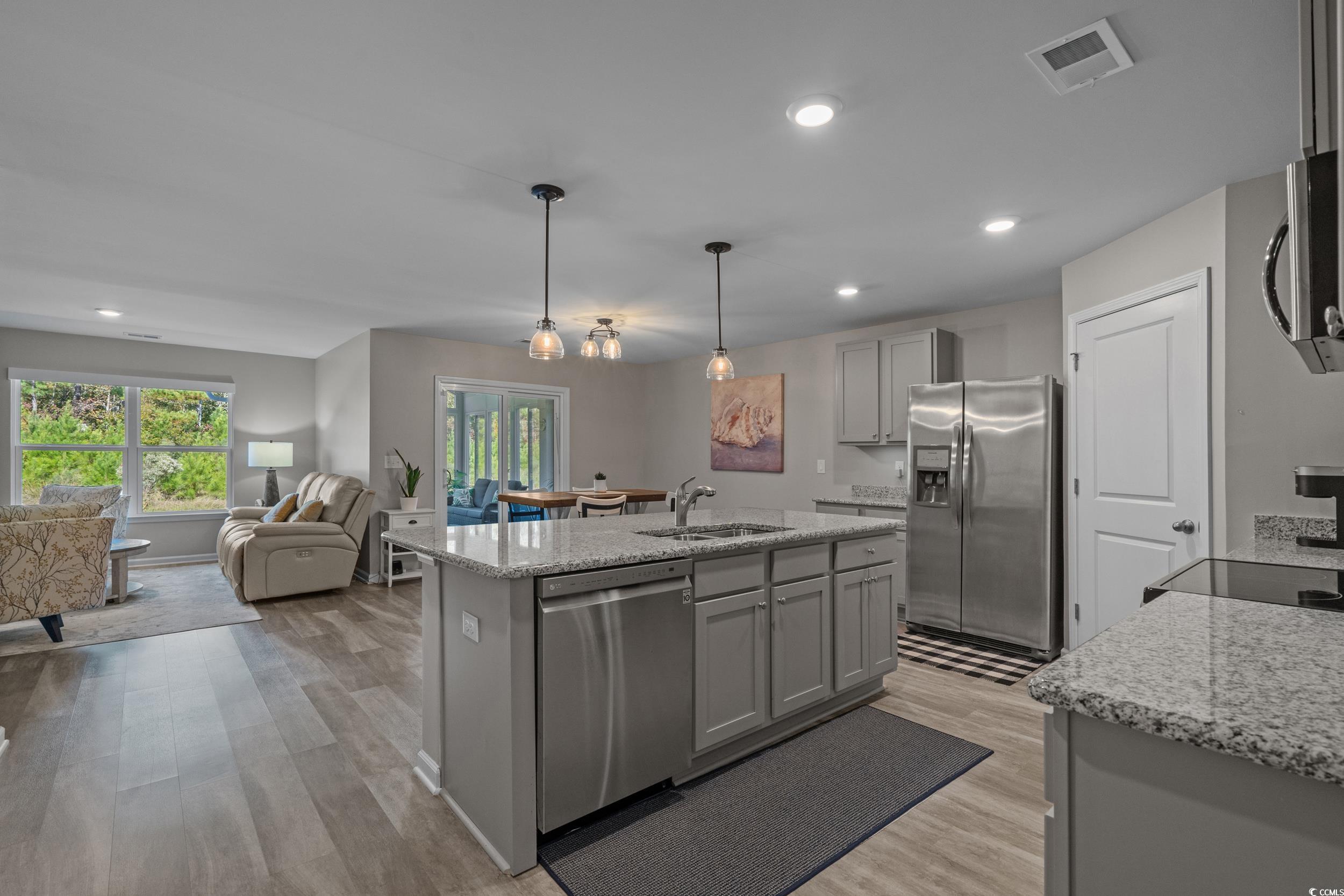 1803 Promise Pl. Myrtle Beach, SC 29588 - Photo 6 of 40 Kitchen featuring gray cabinetry, light stone countertops, light wood-style flooring, appliances with stainless steel finishes, and recessed lighting