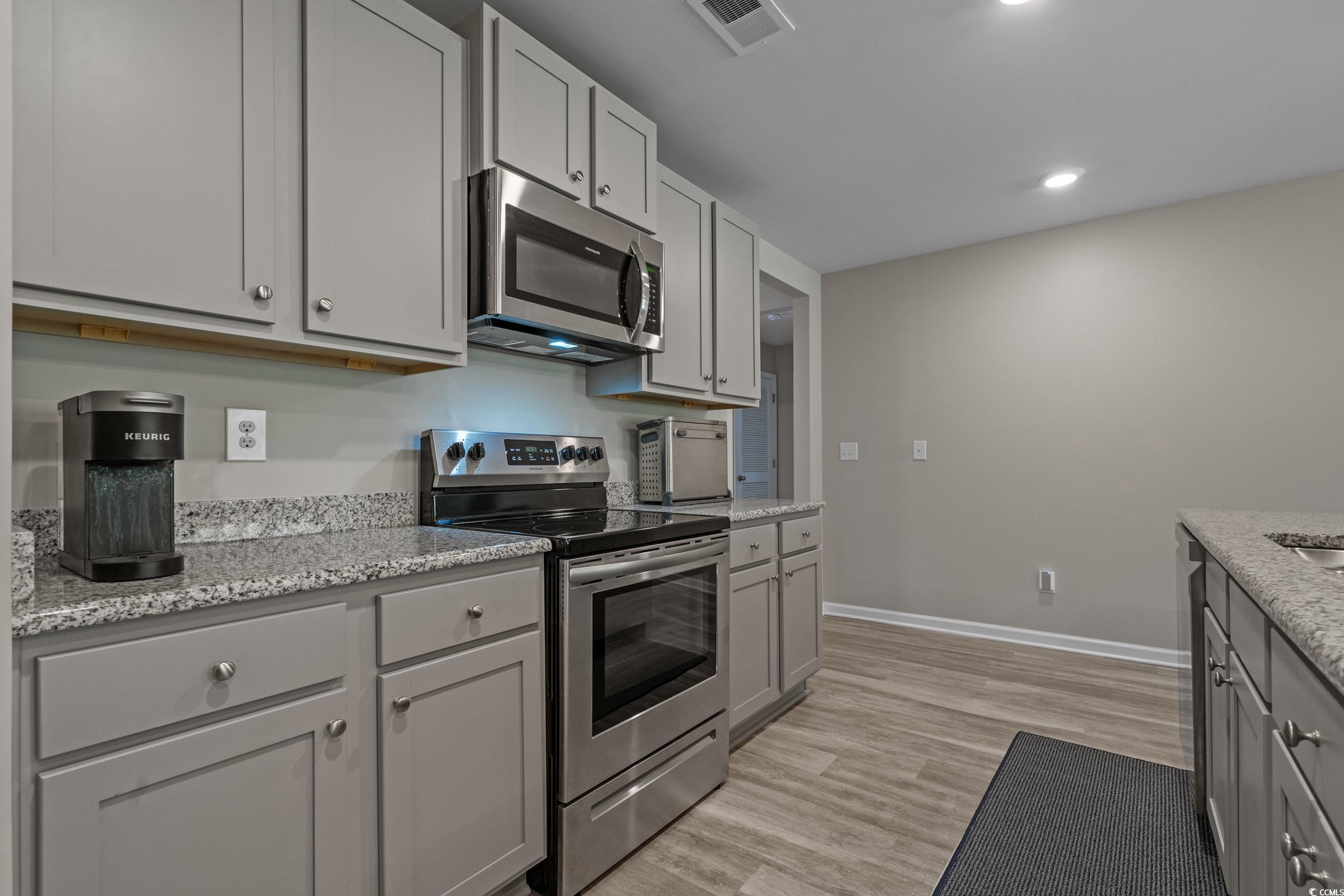 1803 Promise Pl. Myrtle Beach, SC 29588 - Photo 8 of 40 Kitchen with stainless steel appliances, gray cabinets, light stone countertops, light wood-style flooring, and recessed lighting