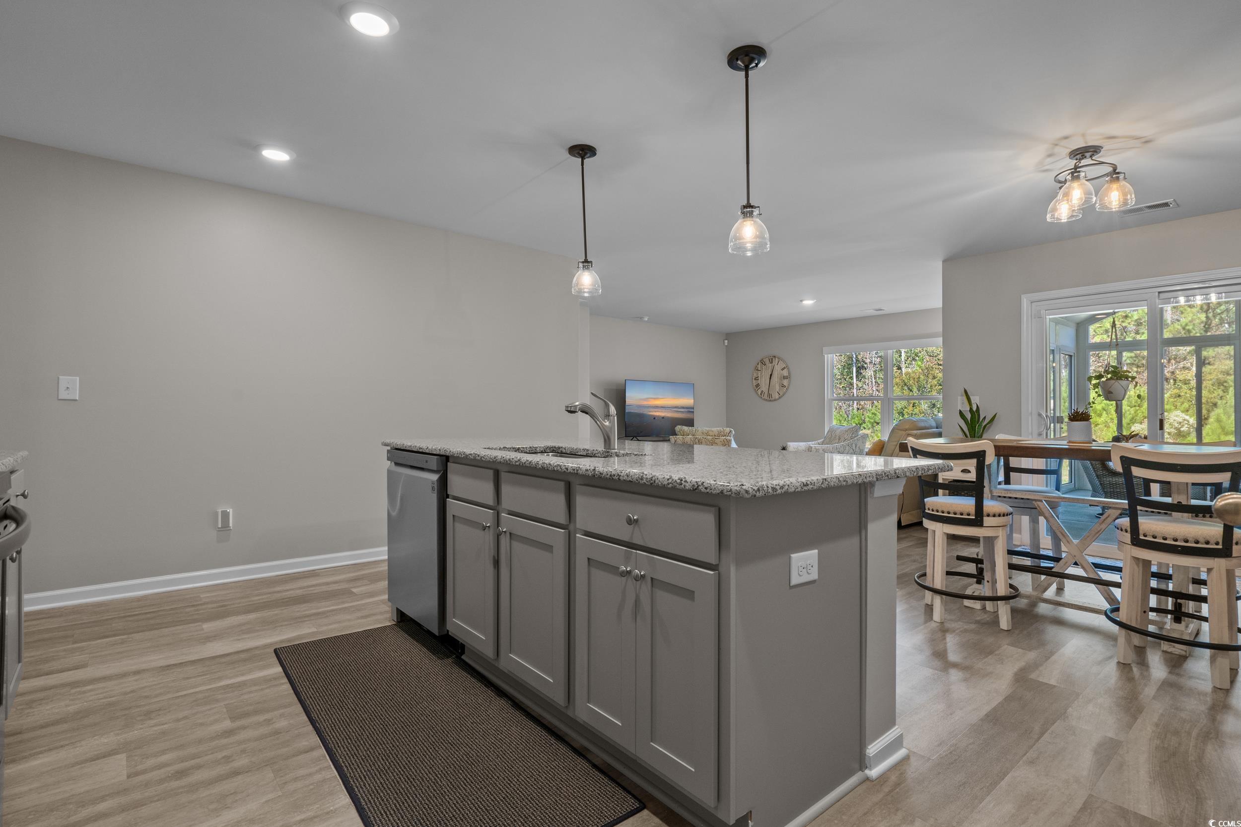 1803 Promise Pl. Myrtle Beach, SC 29588 - Photo 9 of 40 Kitchen with gray cabinets, a center island with sink, decorative light fixtures, recessed lighting, and light wood-style flooring