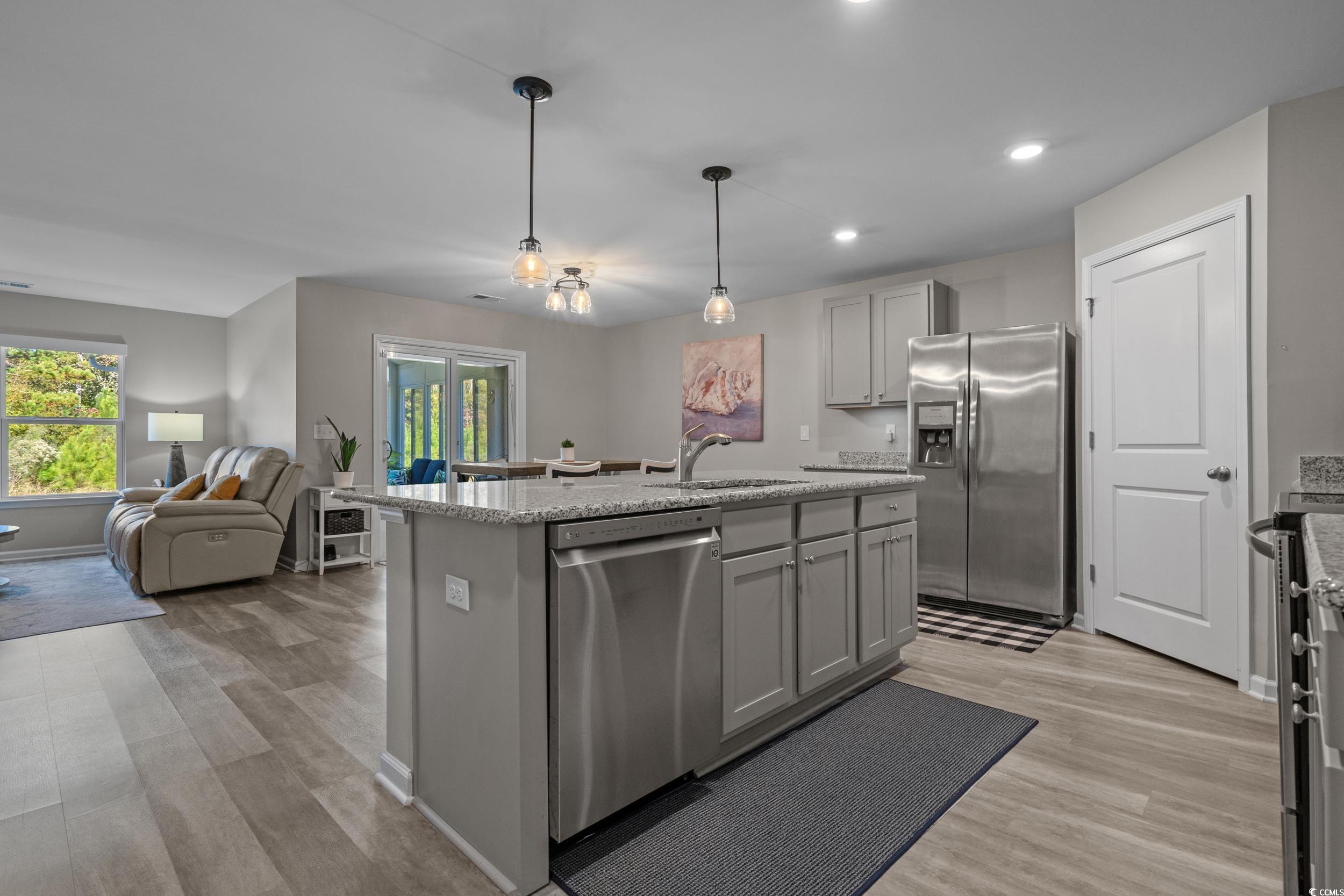 1803 Promise Pl. Myrtle Beach, SC 29588 - Photo 10 of 40 Kitchen with gray cabinetry, stainless steel appliances, light wood-style flooring, light stone counters, and recessed lighting