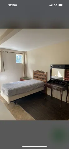 a bedroom with furniture and a lamp