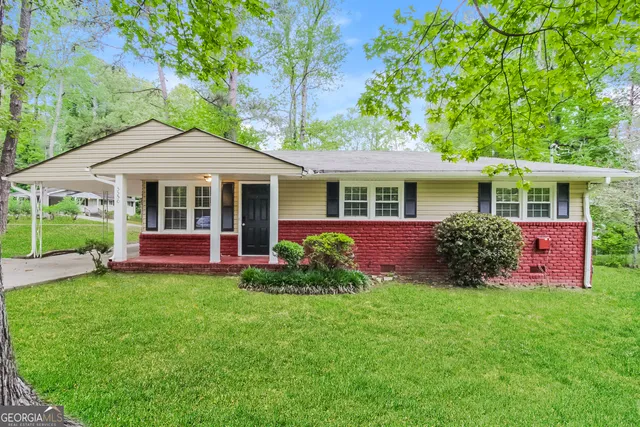 a front view of a house with a yard and porch