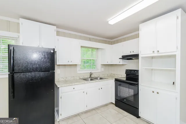a kitchen with a sink and a refrigerator