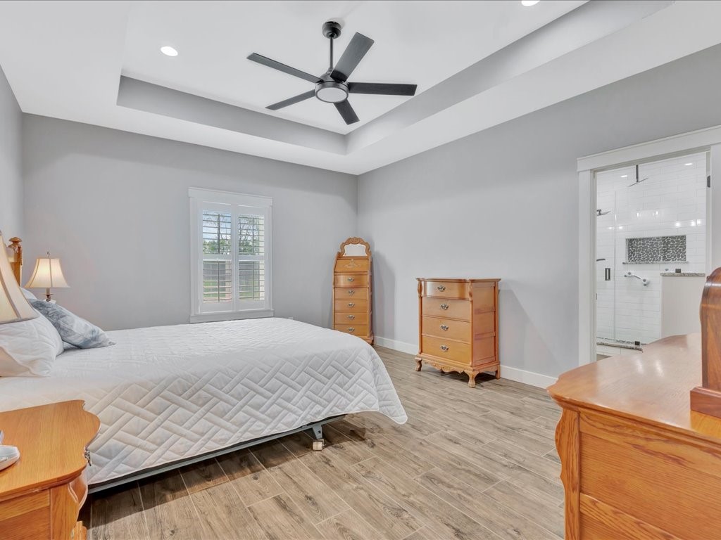 1105 C C Road Diboll, TX 75941 - Photo 23 of 40 a bedroom with a bed a large window and dresser