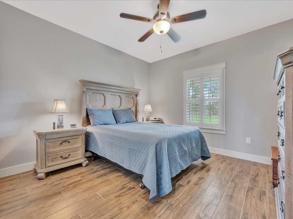 1105 C C Road Diboll, TX 75941 - Photo 28 of 40 a bedroom with a bed and a chandelier