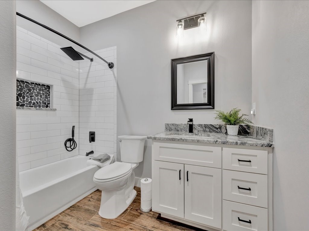 1105 C C Road Diboll, TX 75941 - Photo 29 of 40 a bathroom with a granite countertop sink toilet and shower