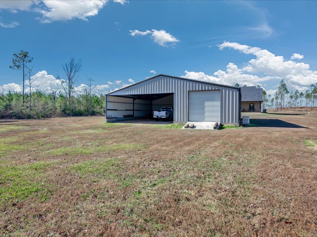 1105 C C Road Diboll, TX 75941 - Photo 39 of 40 a view of a house with a yard and garage