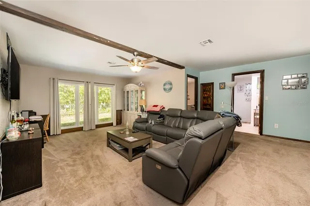 a living room with furniture window and a flat screen tv