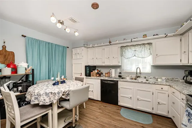 a kitchen with a sink stove and cabinets