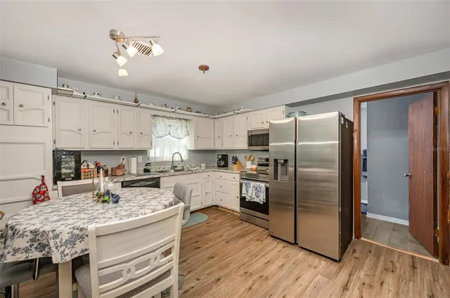 a kitchen with stainless steel appliances granite countertop a refrigerator and a stove top oven