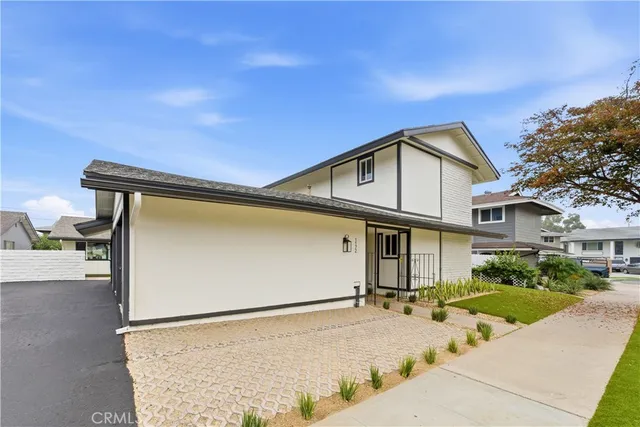a view of a house with a wooden fence