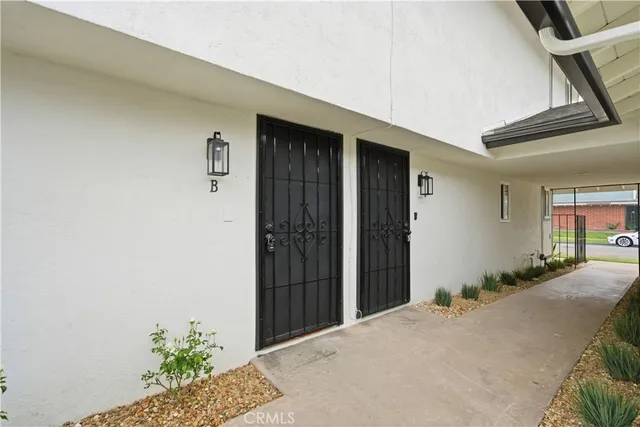 a view of a house with a potted plant and garage