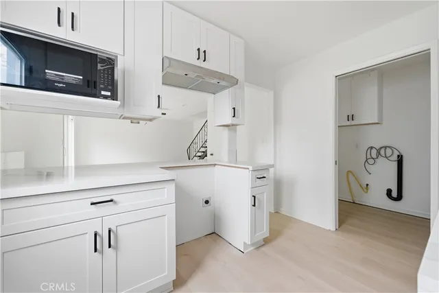 a view of cabinets and wooden floor