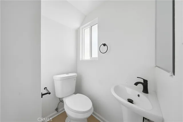 a white toilet sitting next to a bathroom sink