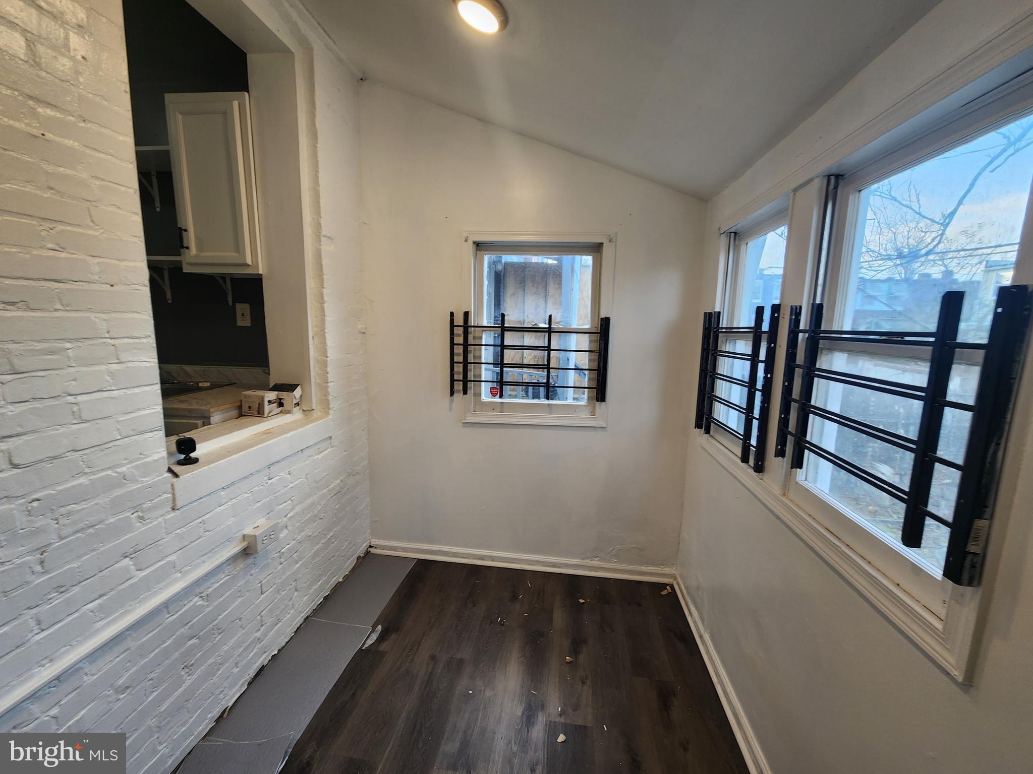 810 Appleton Street Baltimore, MD 21217 - Photo 11 of 27 a view of an empty room with wooden floor and a window