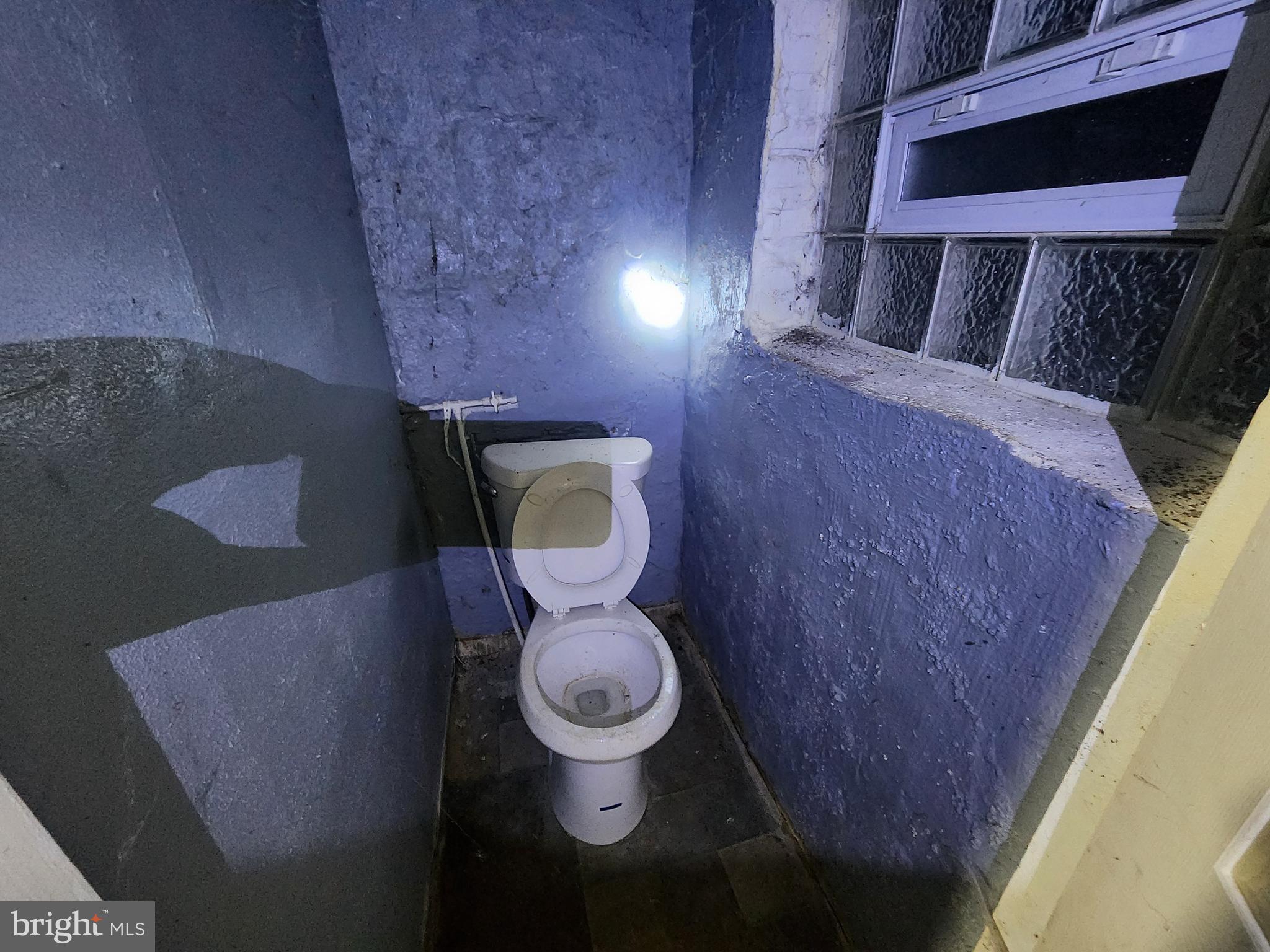 810 Appleton Street Baltimore, MD 21217 - Photo 17 of 27 a bathroom with a toilet and a mirror