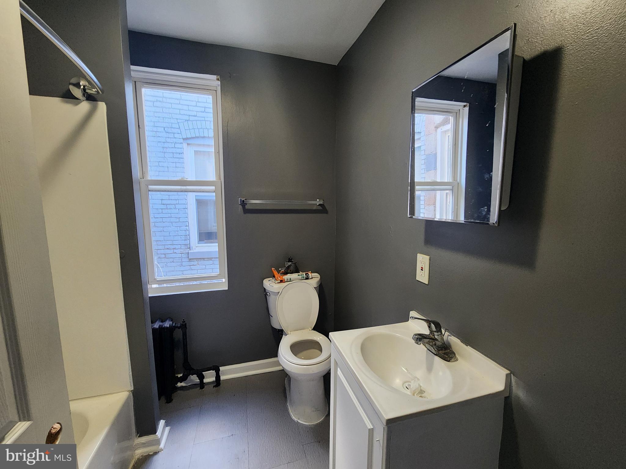 810 Appleton Street Baltimore, MD 21217 - Photo 23 of 27 a bathroom with a sink toilet and mirror