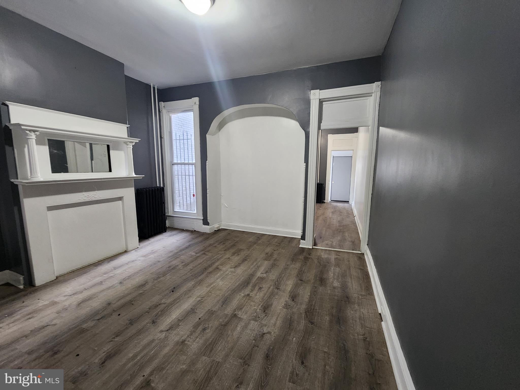 810 Appleton Street Baltimore, MD 21217 - Photo 6 of 27 a view of empty room with wooden floor