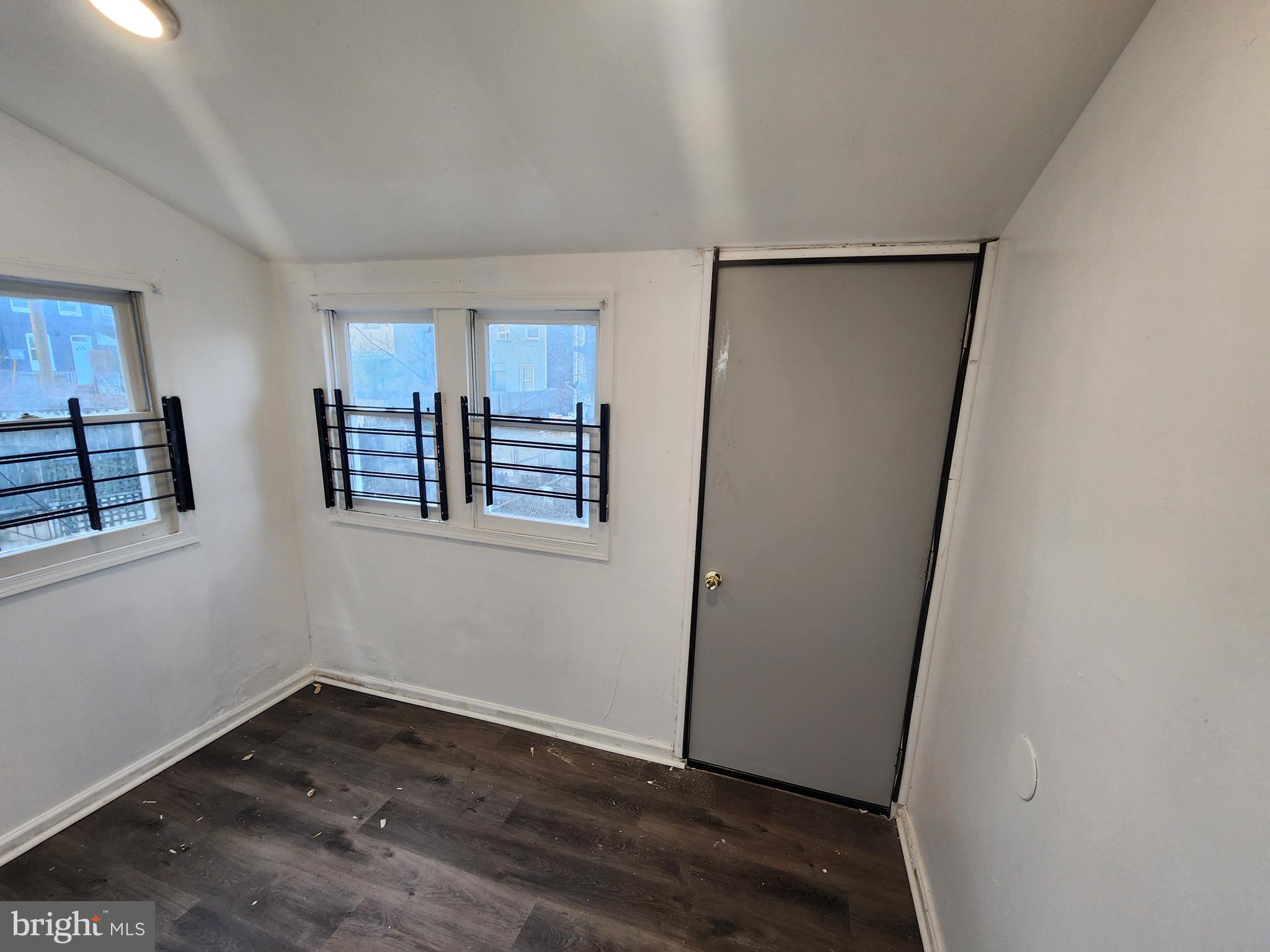 810 Appleton Street Baltimore, MD 21217 - Photo 9 of 27 a view of empty room with wooden floor and fan