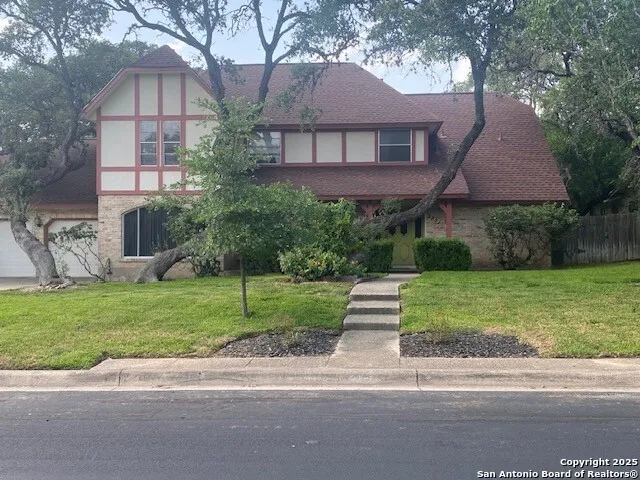 a front view of house with yard and green space