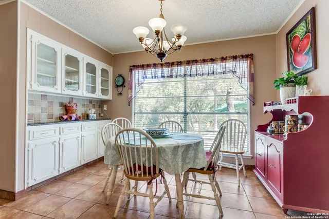 a dining room with furniture a livingroom and chandelier