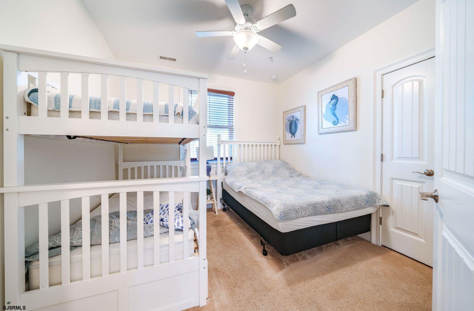 901 Wesley Avenue, Unit B Ocean City, NJ 08226 - Photo 15 of 33 a bedroom with a bed and window