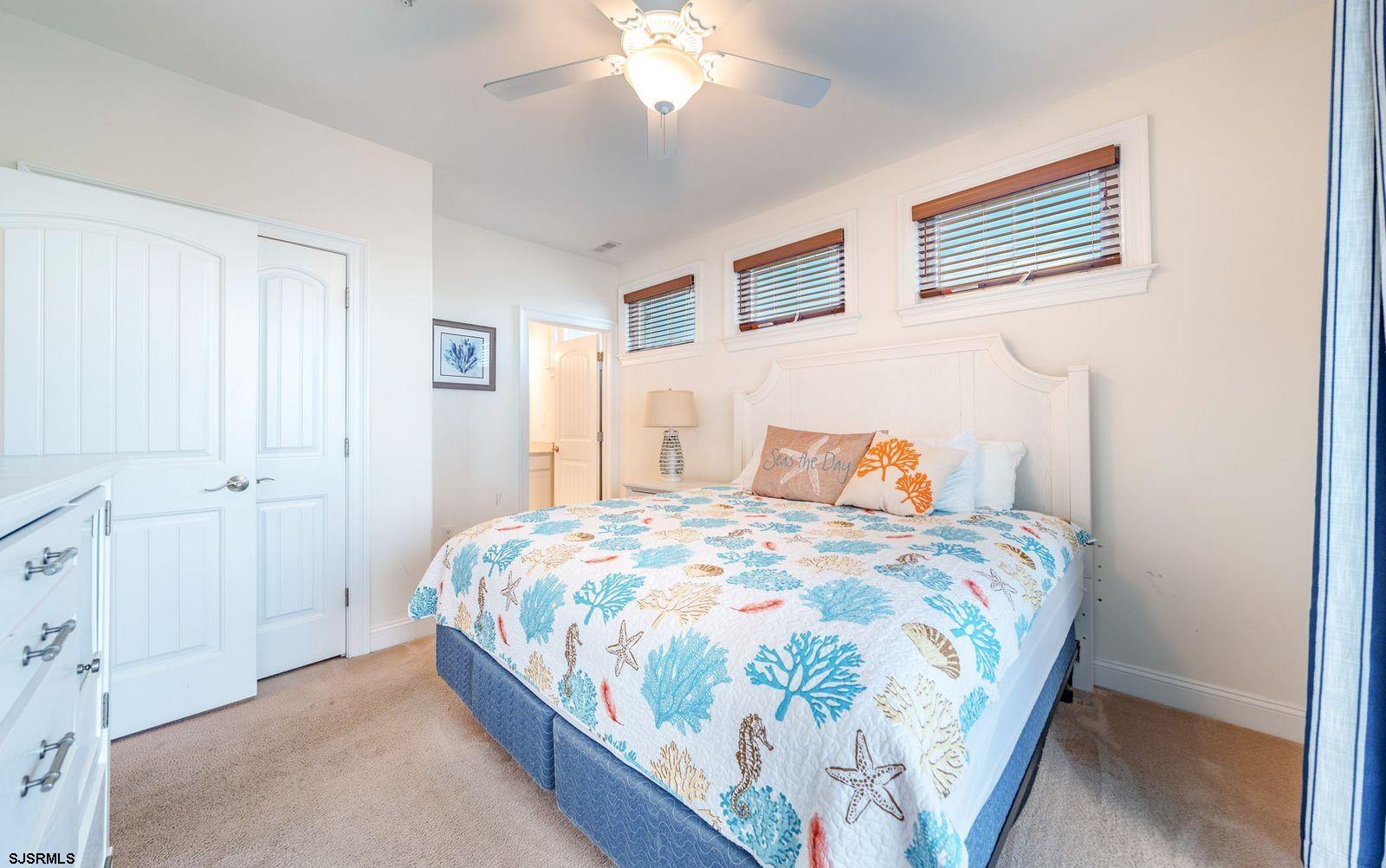 901 Wesley Avenue, Unit B Ocean City, NJ 08226 - Photo 17 of 33 a bedroom with a bed and a chandelier