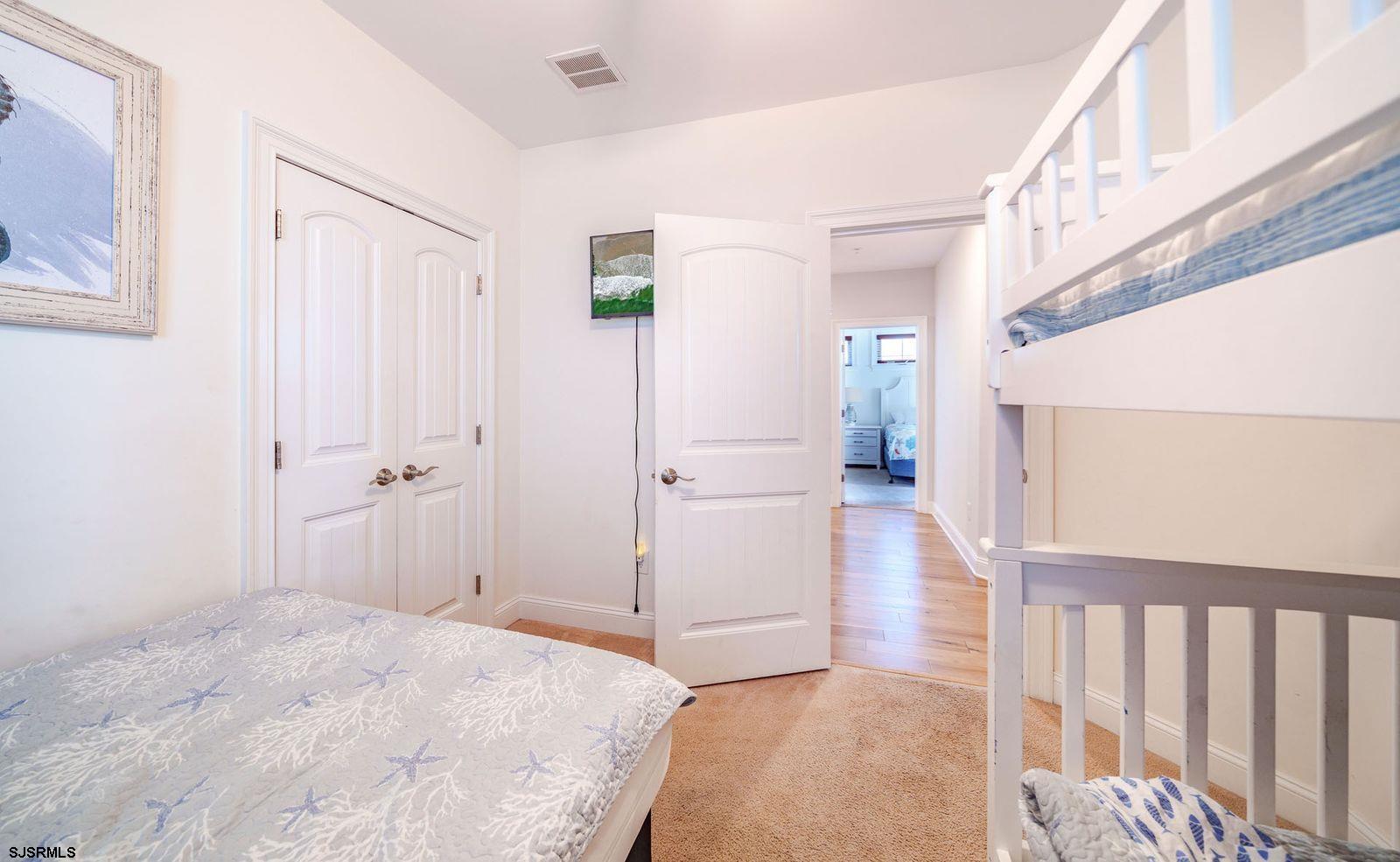 901 Wesley Avenue, Unit B Ocean City, NJ 08226 - Photo 18 of 33 a view of a hallway with wooden floor and staircase