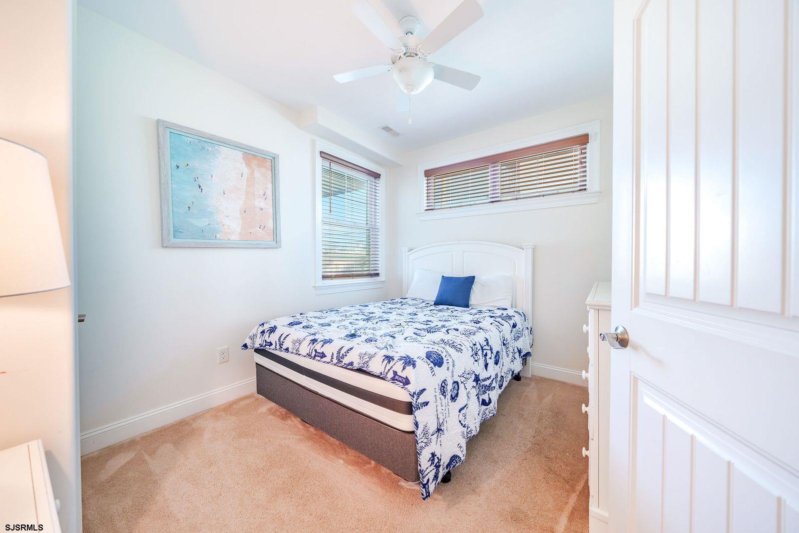 901 Wesley Avenue, Unit B Ocean City, NJ 08226 - Photo 21 of 33 a bedroom with a bed rug and window