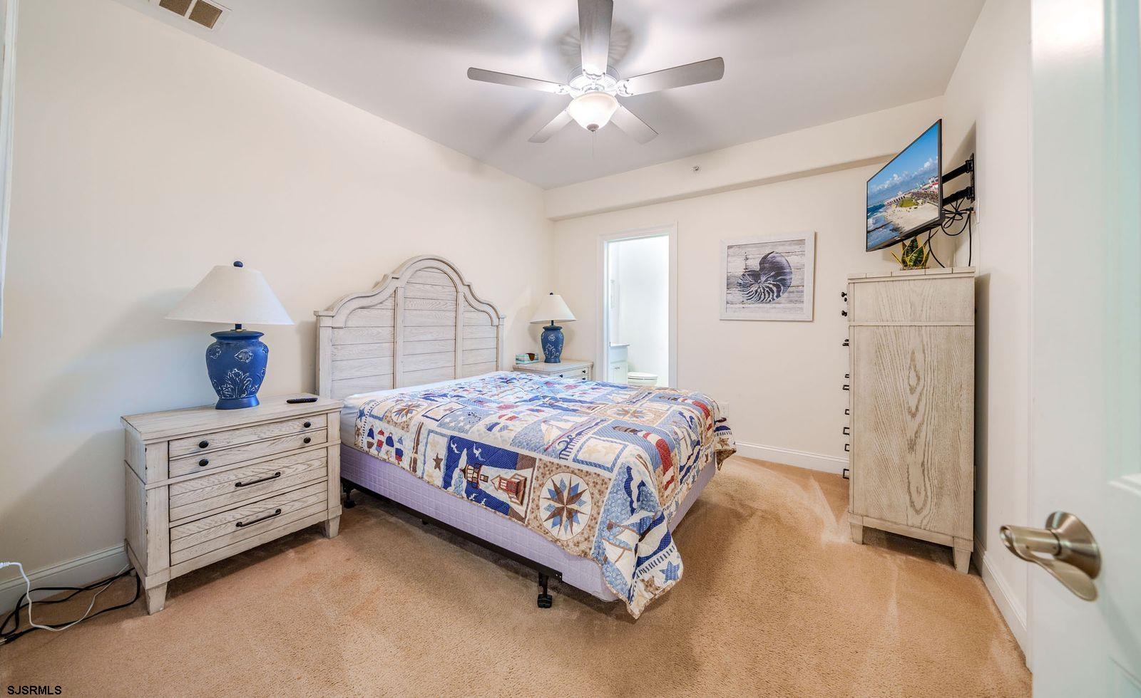 901 Wesley Avenue, Unit B Ocean City, NJ 08226 - Photo 22 of 33 a bedroom with a bed dresser and a window