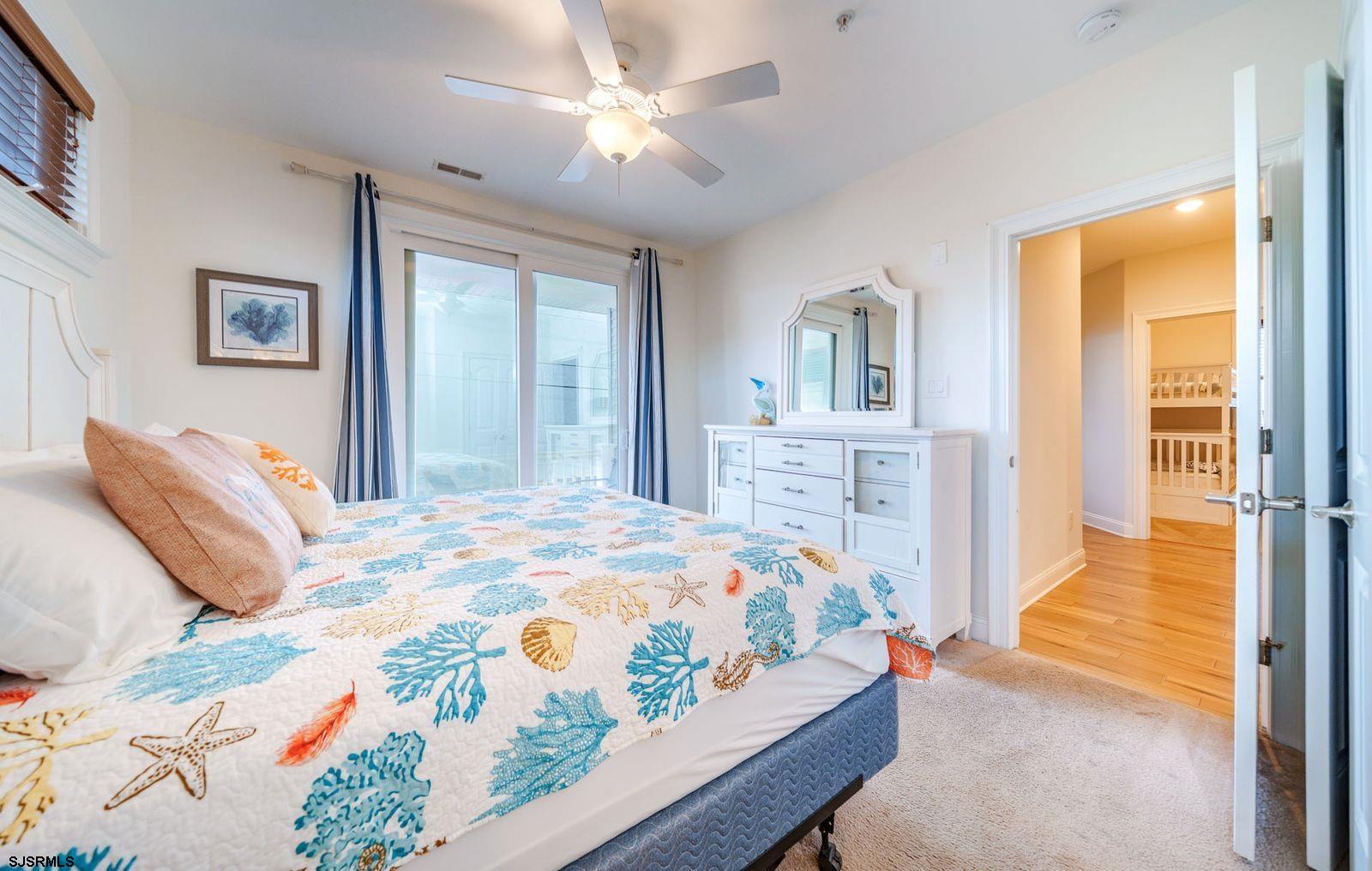 901 Wesley Avenue, Unit B Ocean City, NJ 08226 - Photo 23 of 33 a bedroom with a bed dresser and a window