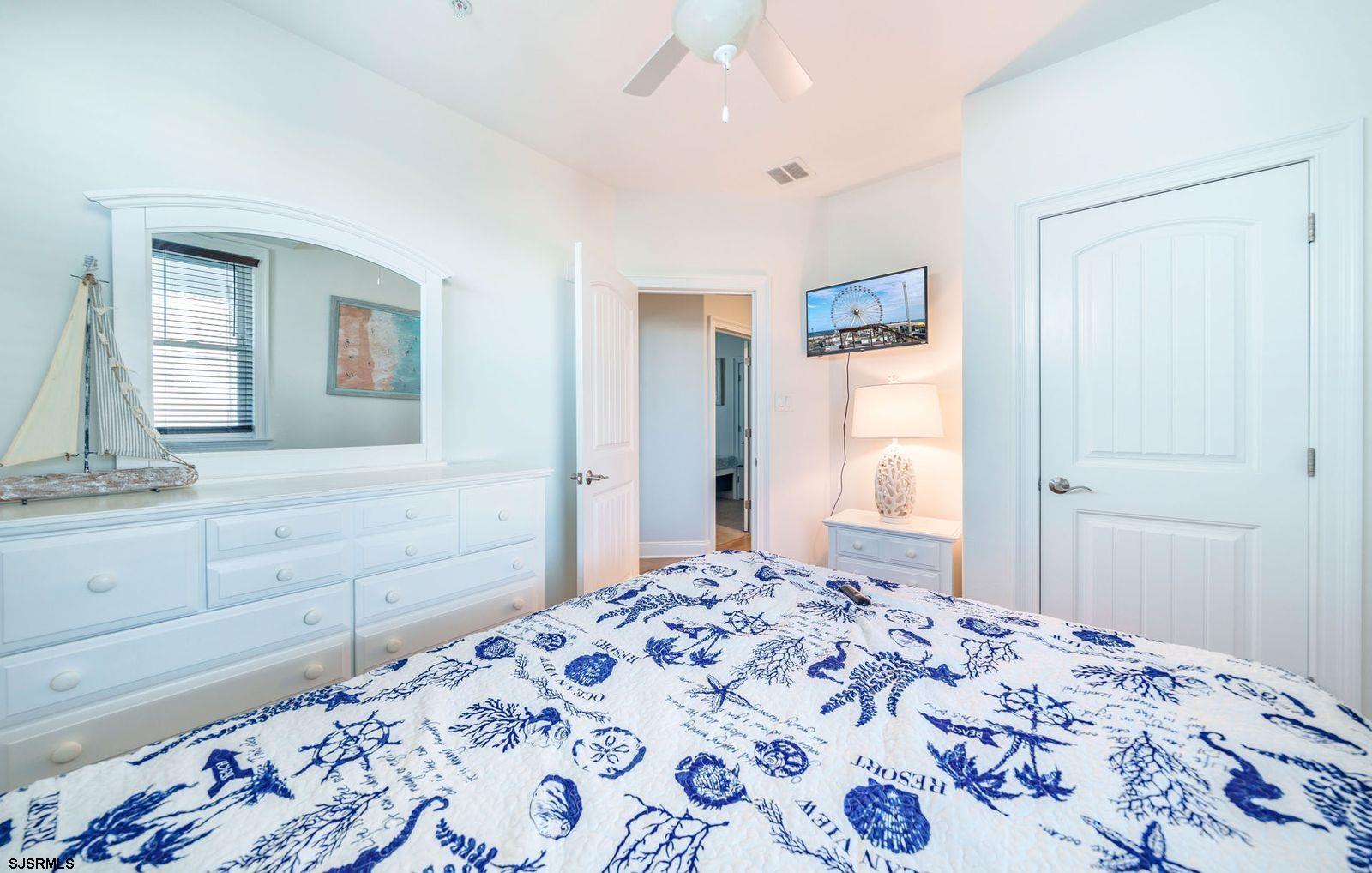 901 Wesley Avenue, Unit B Ocean City, NJ 08226 - Photo 25 of 33 a bedroom with a bed and a dresser in it