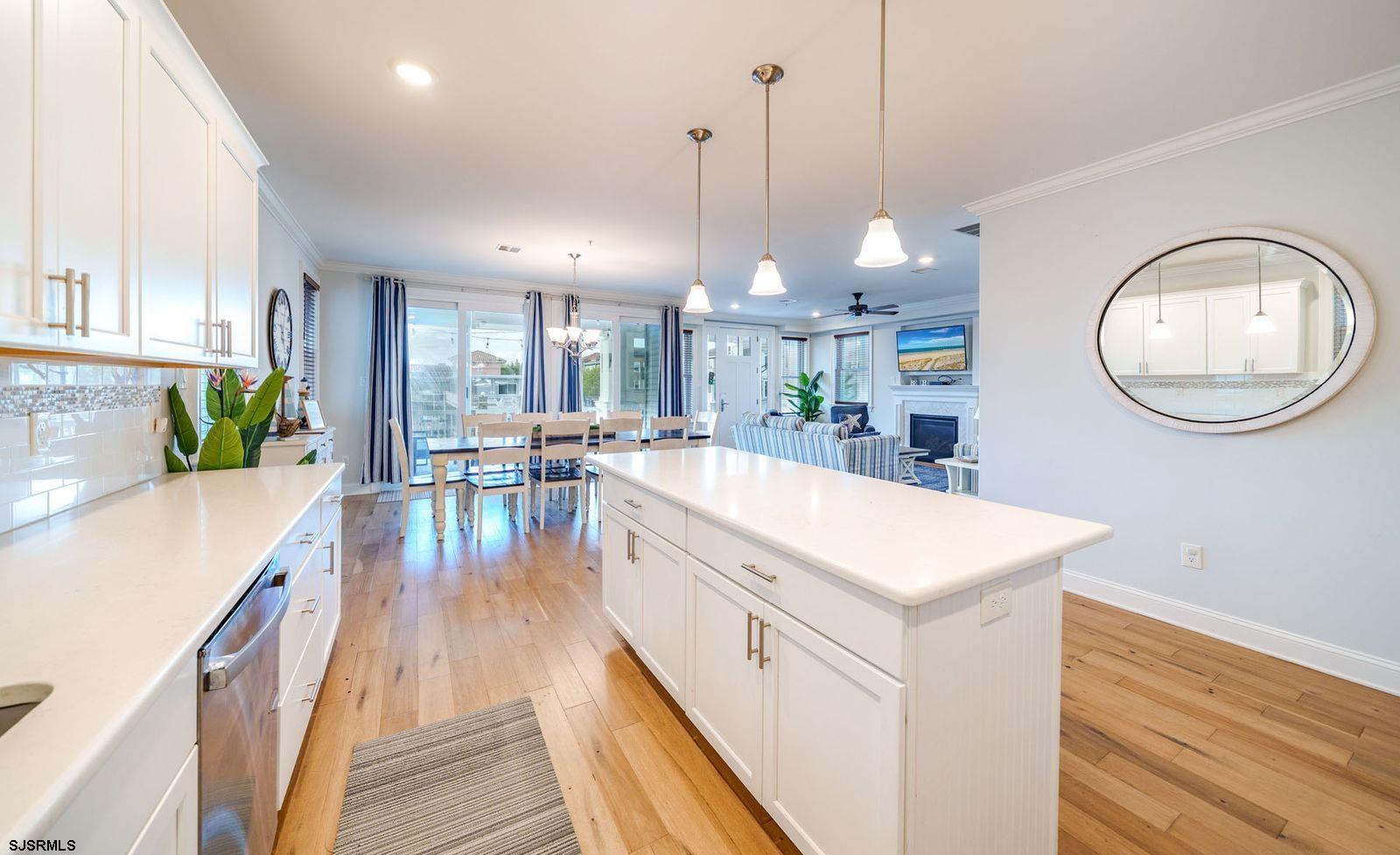 901 Wesley Avenue, Unit B Ocean City, NJ 08226 - Photo 3 of 33 a view of a kitchen with kitchen island a stove a refrigerator a oven a dining table with wooden floor