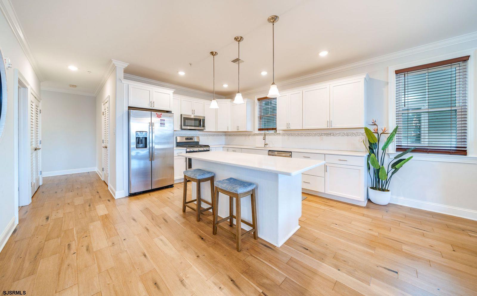 901 Wesley Avenue, Unit B Ocean City, NJ 08226 - Photo 4 of 33 a kitchen with stainless steel appliances granite countertop a sink a stove a refrigerator and a wooden floors